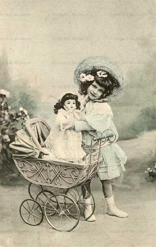do091-Edwardian Girl Playing with Big Doll and Old Victorian Toy