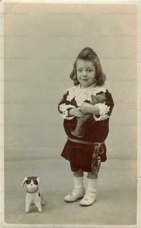 dob041-Girl Held Teddy Bear in Her Arms and a Dog